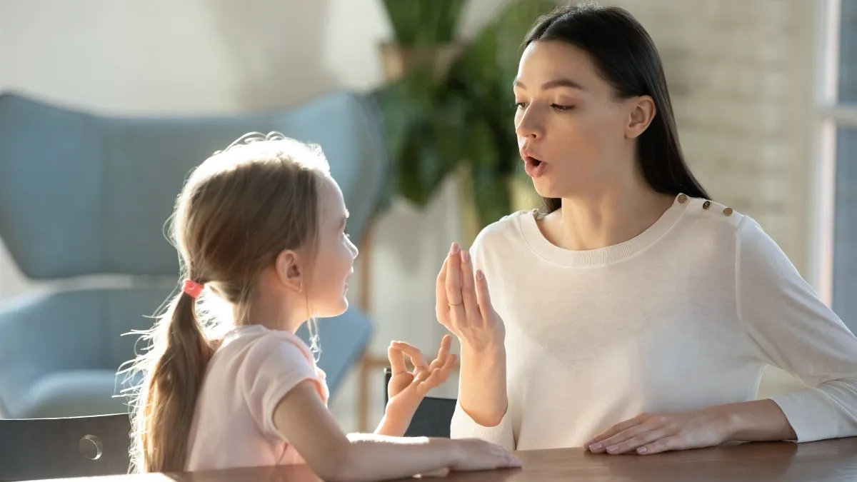 a mom and a child sitting at a table