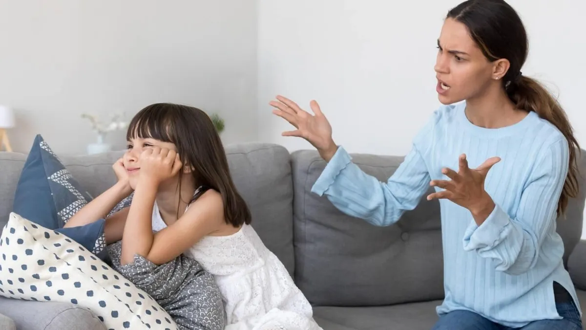 a mom yelling at a girl child